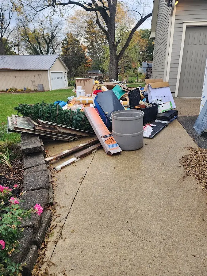 Dumpster being loaded with debris for Roofing Dumpster Rental in Kirkland